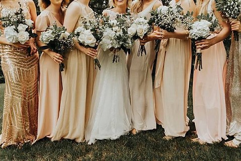 closeup of the bridesmaids bouquets of all white flowers