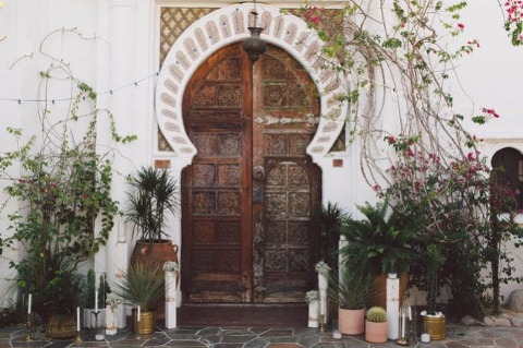 This wild and wayward framing of the door piques interest and provides a glimpse of what's ahead for the wedding day. Credit: Sposto Photography
